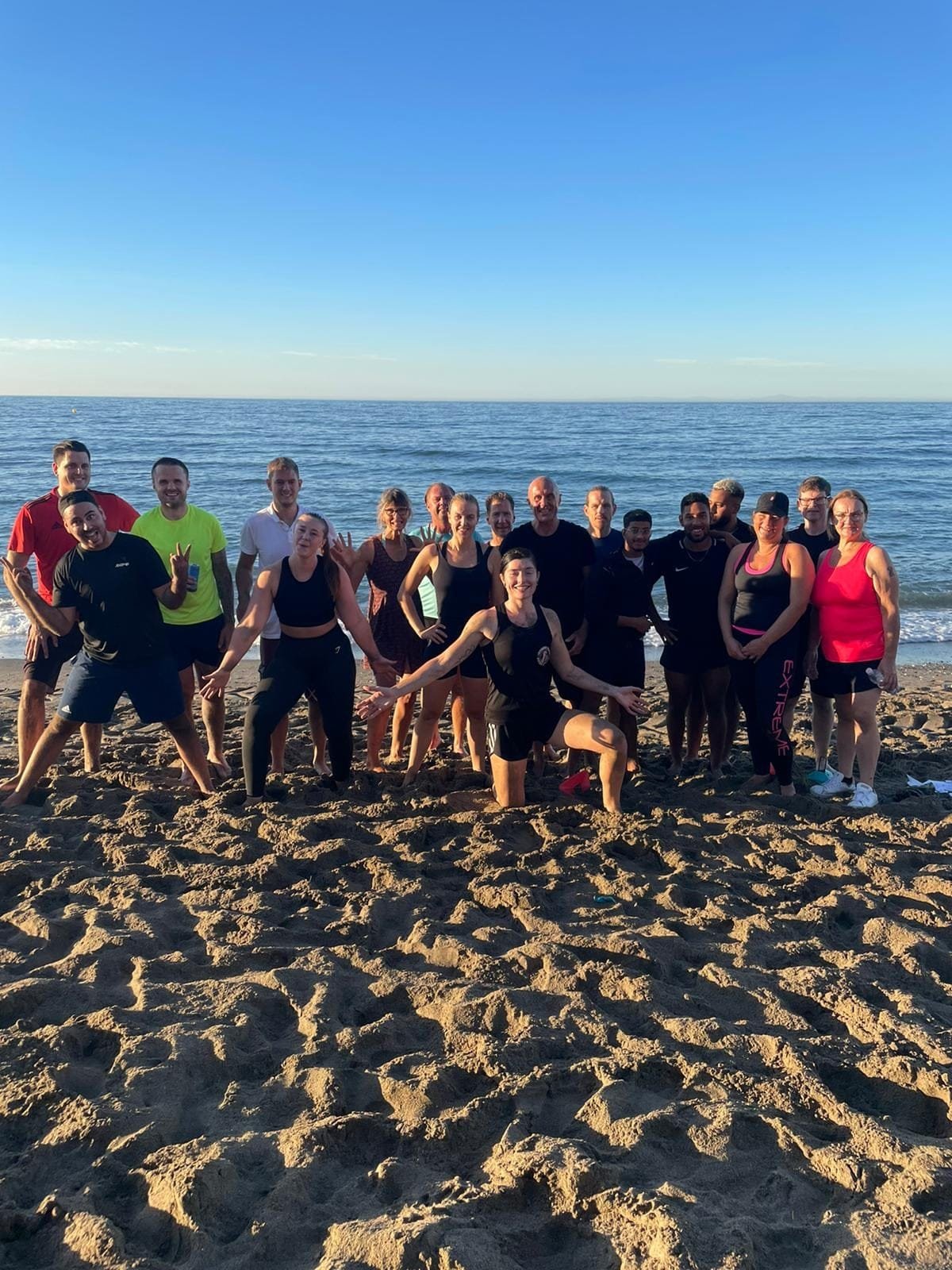Large corporate team fitness group on the beach in Marbella