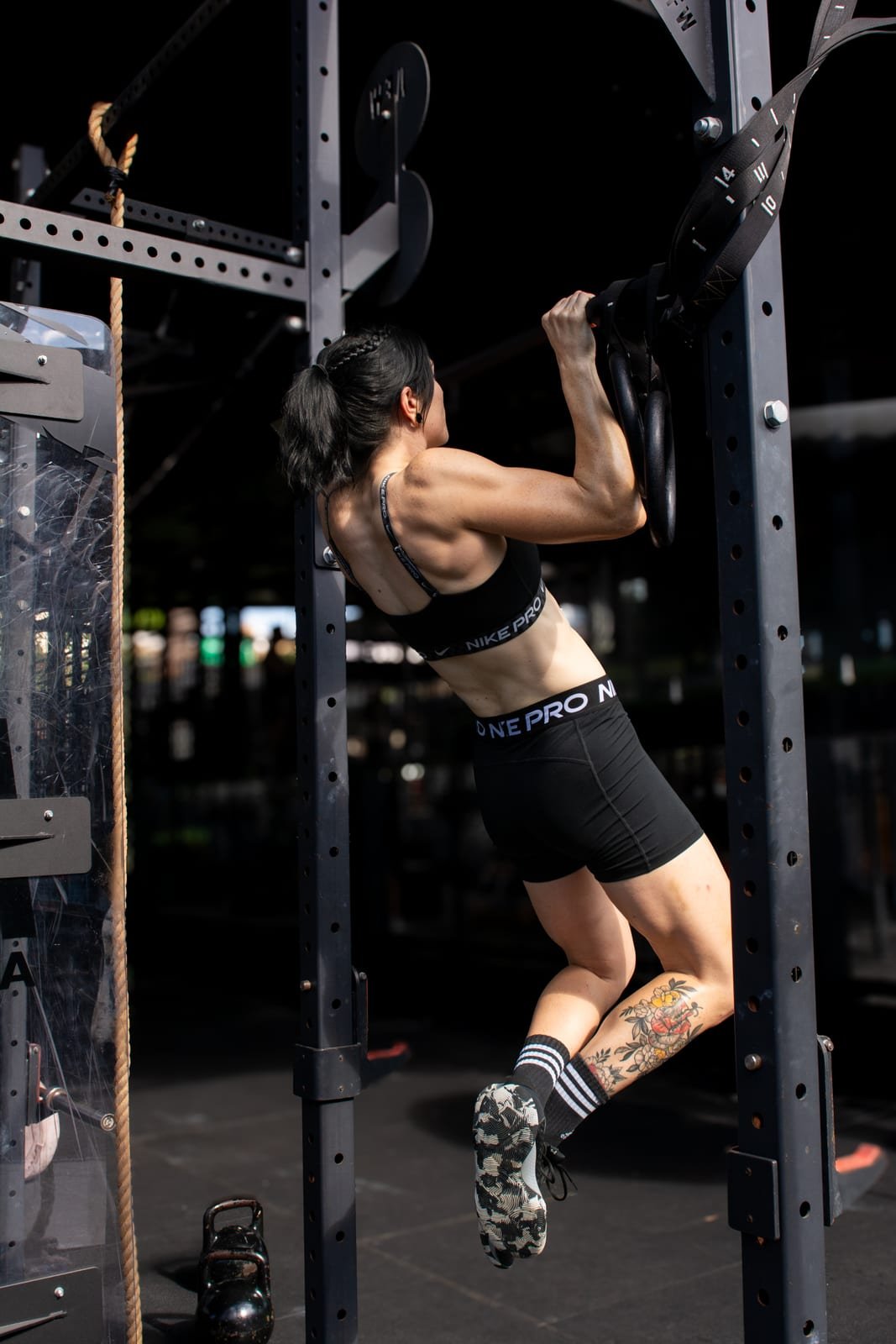 Client performing a strict pull-up during a strength training session